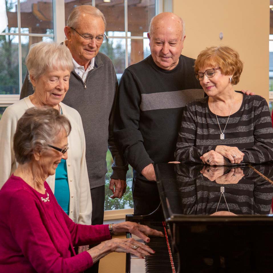 The Carriage House seniors playing piano