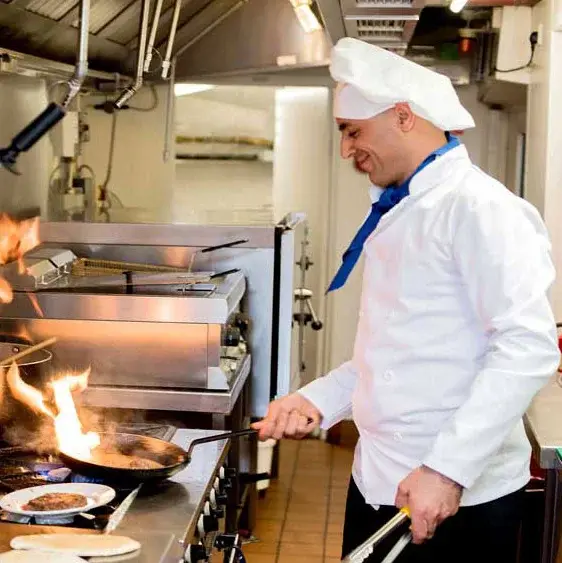 Hawthorn Senior Living Chef Created Meals, chef frying a dish.